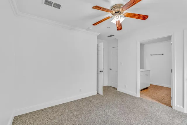 a view of a room with a ceiling fan and a chandelier fan