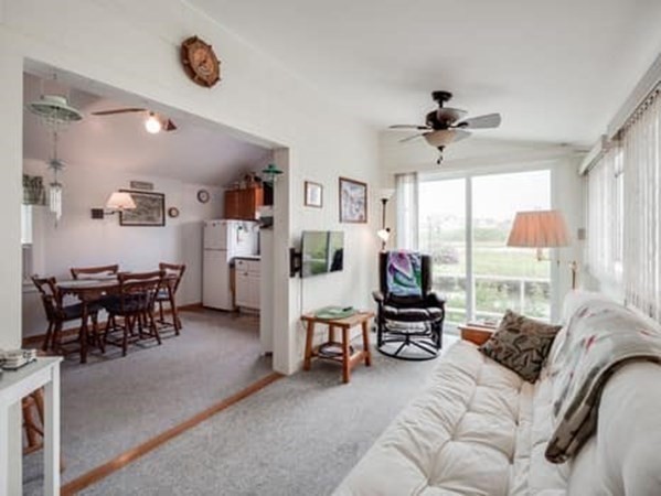554 Winnacunnet Road, Unit A Hampton, NH 03842 - Photo 5 of 19 a living room with furniture and a flat screen tv