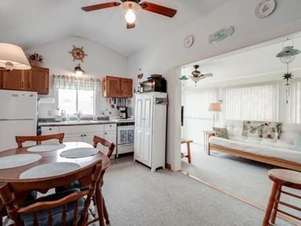 554 Winnacunnet Road, Unit A Hampton, NH 03842 - Photo 6 of 19 a living room with furniture and a chandelier