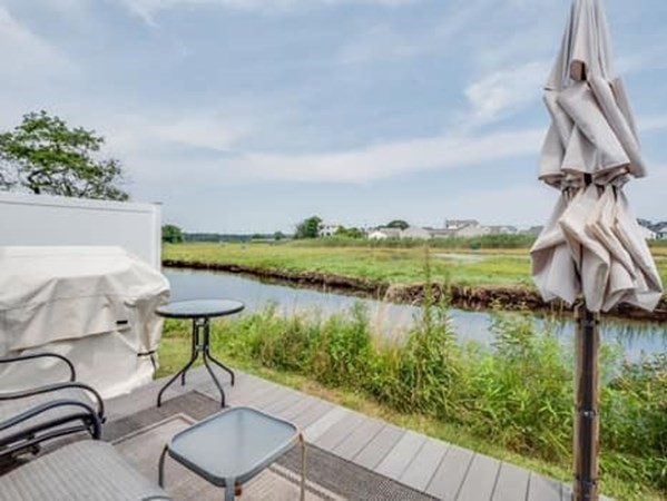 554 Winnacunnet Road, Unit A Hampton, NH 03842 - Photo 10 of 19 a view of a lake with a table and chairs