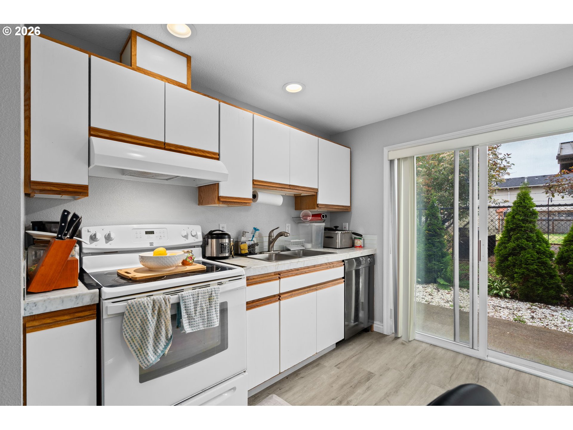 18220 Southeast Pine Street Portland, OR 97233 - Photo 5 of 14 a kitchen with stainless steel appliances granite countertop a stove a sink and a refrigerator