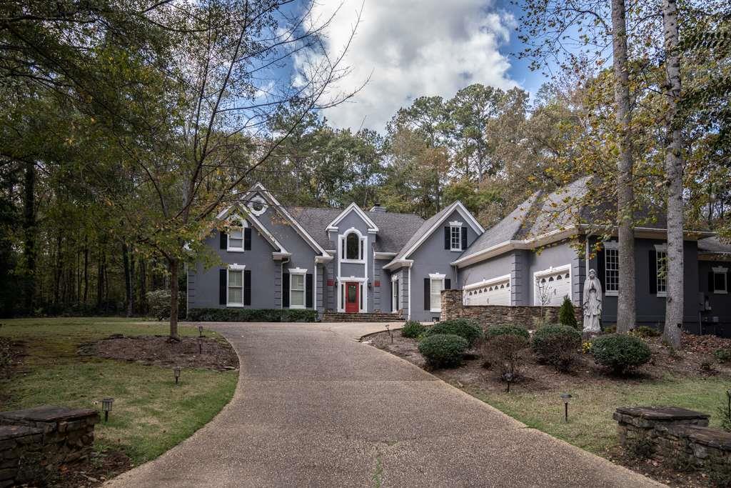 a front view of a house with a garden