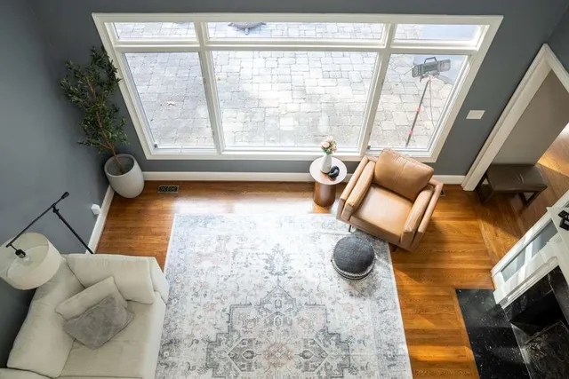 a kitchen with stainless steel appliances granite countertop a table chairs and a refrigerator