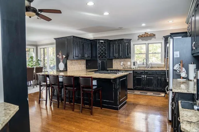 a kitchen with stainless steel appliances granite countertop a stove and a refrigerator