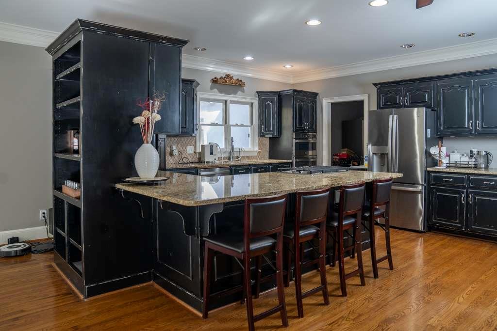 21 River Pine Drive Southwest Rome, GA 30165 - Photo 16 of 64 a kitchen with stainless steel appliances granite countertop a table chairs and a refrigerator