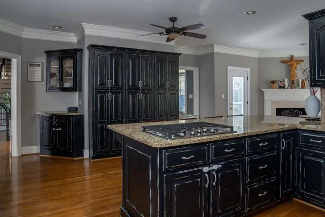 a bathroom with a granite countertop a sink and a mirror
