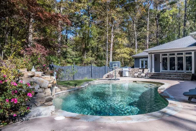 a view of a house with backyard and sitting area