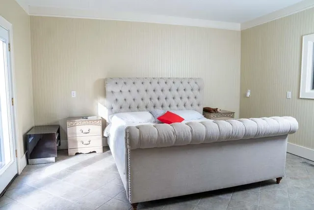 a bedroom with a bed and window