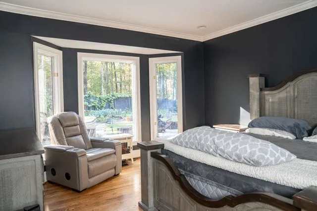 a bedroom with furniture and a window