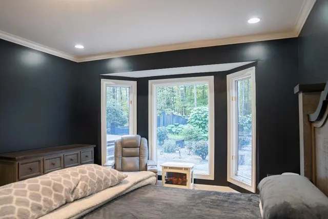 a spacious bedroom with a bed and a window