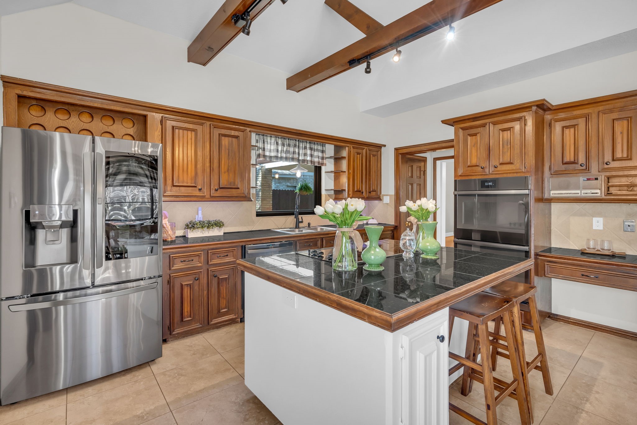 6034 Oak Creek Lane Spring, TX 77379 - Photo 14 of 42 This Kitchen displays tile flooring, custom cabinetry, granite countertops, and stainless steel appliances! 6034 Oak Creek Ln., Spring, TX 77379