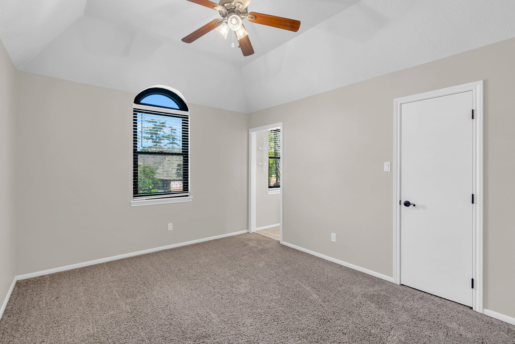 6034 Oak Creek Lane Spring, TX 77379 - Photo 32 of 42 Secondary Bedroom featuring lots of natural light, high ceilings and a ceiling fan overlooking the front of the House! 6034 Oak Creek Ln., Spring, TX 77379