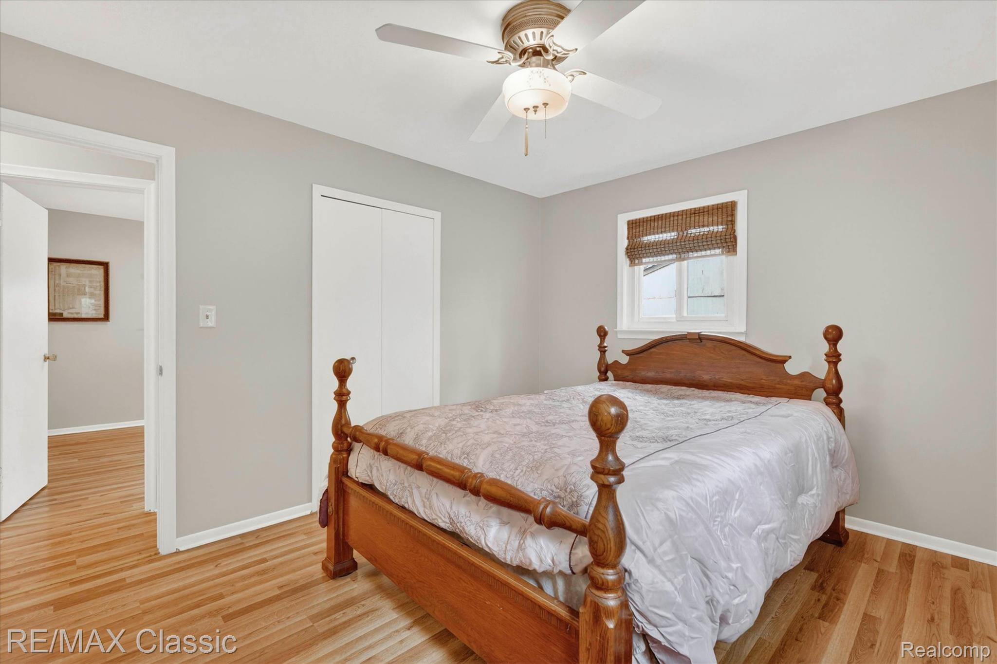5060 Warmbriar Road White Lake, MI 48383 - Photo 12 of 34 Bedroom featuring light wood-type flooring, a ceiling fan, and a closet