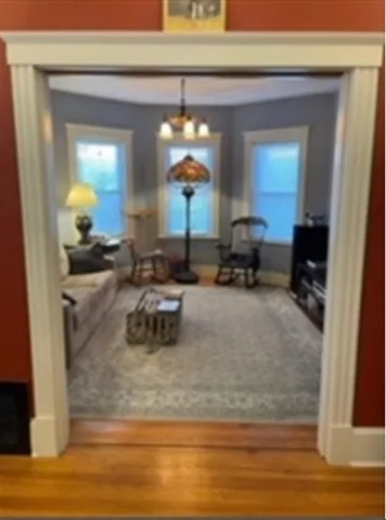 a living room with furniture and a mirror