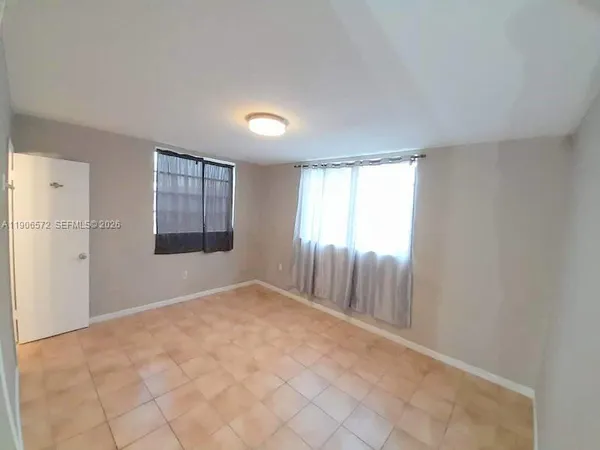 a view of an empty room with a window