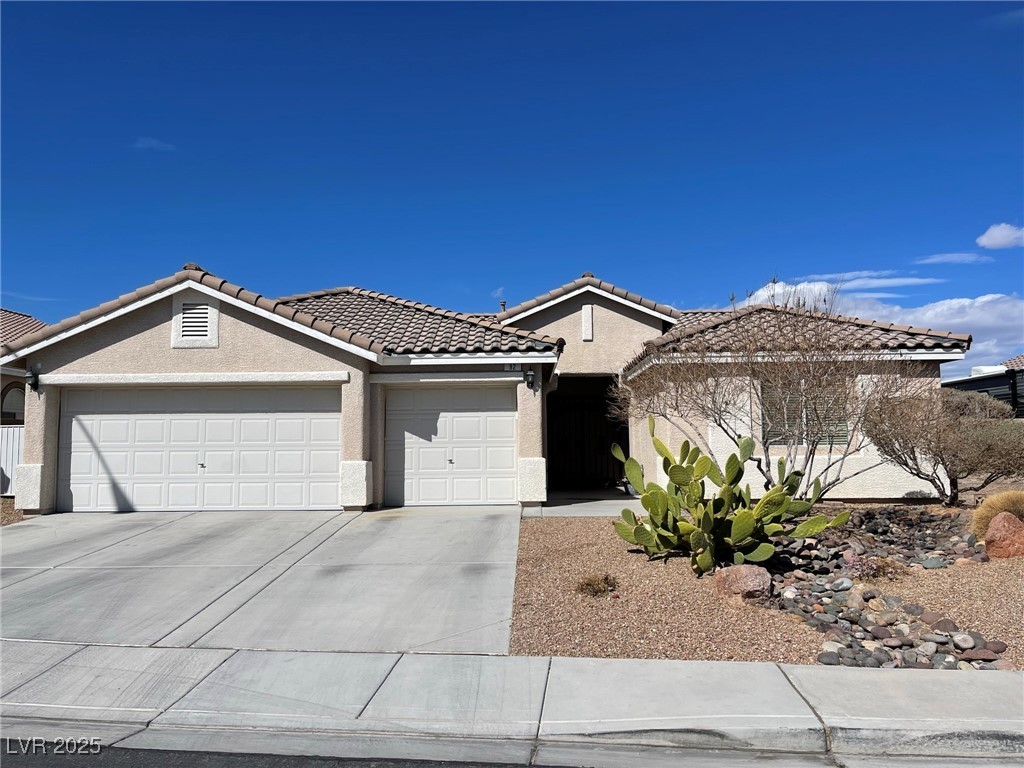 92 Whitetail Archery Avenue North Las Vegas, NV 89084 - Photo 1 of 33 Single story home featuring stucco siding, driveway, an attached garage, and a tiled roof