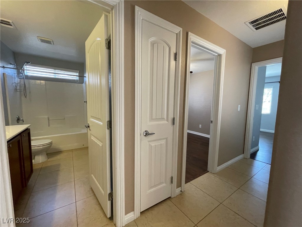 92 Whitetail Archery Avenue North Las Vegas, NV 89084 - Photo 12 of 33 Full bath featuring light tile patterned flooring, vanity, and shower / bathtub combination