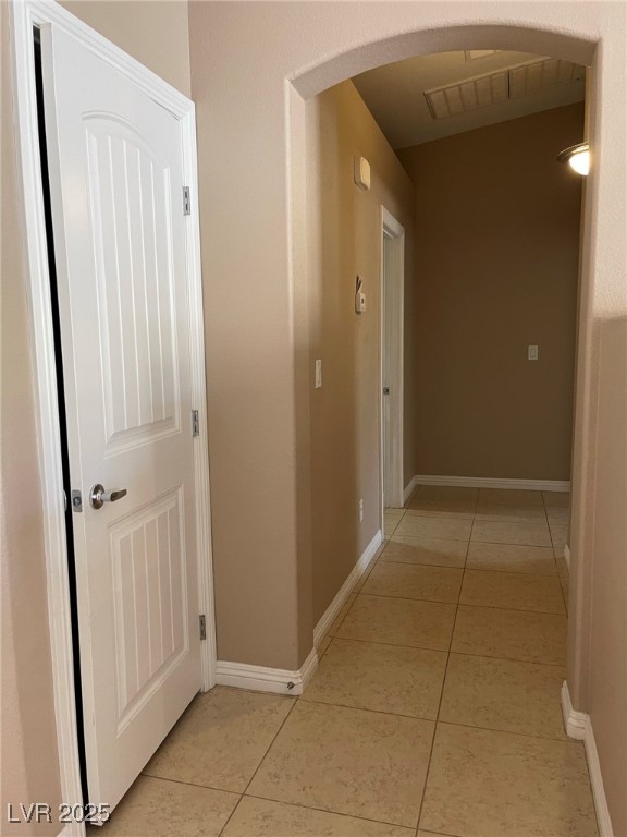 92 Whitetail Archery Avenue North Las Vegas, NV 89084 - Photo 13 of 33 Hallway with arched walkways and light tile patterned flooring