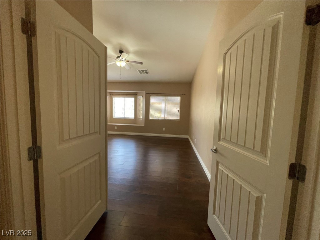 92 Whitetail Archery Avenue North Las Vegas, NV 89084 - Photo 15 of 33 Spare room featuring a ceiling fan and dark wood finished floors