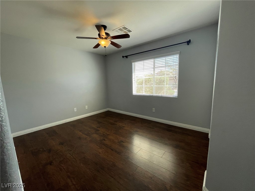 92 Whitetail Archery Avenue North Las Vegas, NV 89084 - Photo 27 of 33 Unfurnished room featuring dark wood-style flooring and ceiling fan