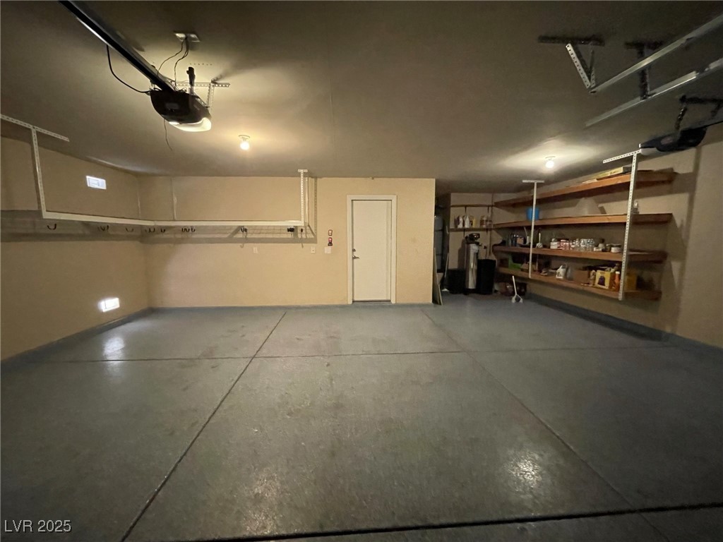 92 Whitetail Archery Avenue North Las Vegas, NV 89084 - Photo 29 of 33 Garage featuring a garage door opener