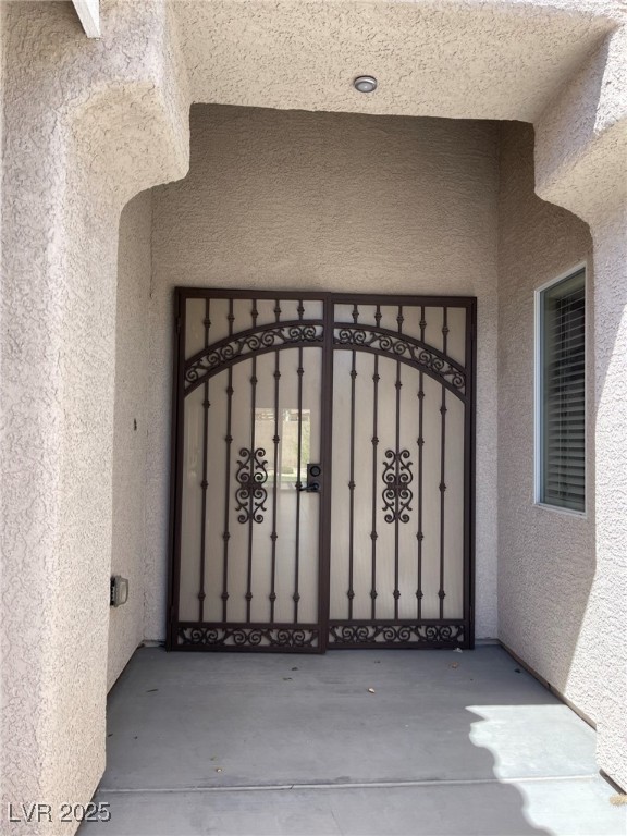 92 Whitetail Archery Avenue North Las Vegas, NV 89084 - Photo 3 of 33 Doorway to property with stucco siding