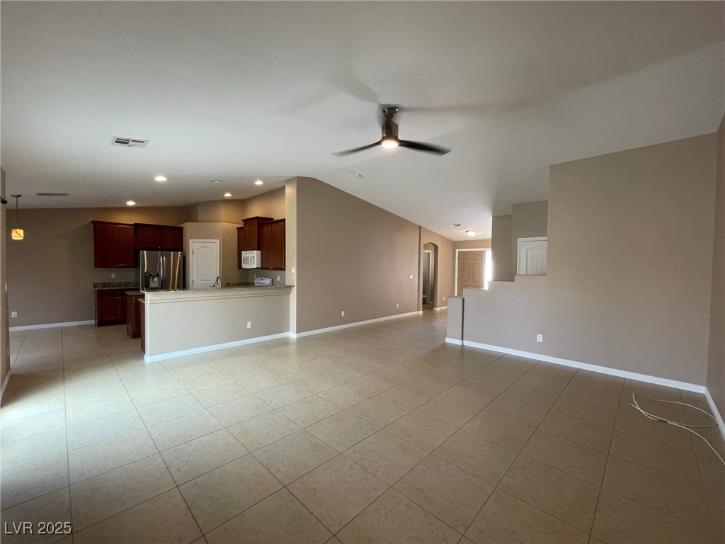 92 Whitetail Archery Avenue North Las Vegas, NV 89084 - Photo 6 of 33 Unfurnished living room featuring vaulted ceiling, light tile patterned flooring, a ceiling fan, and recessed lighting
