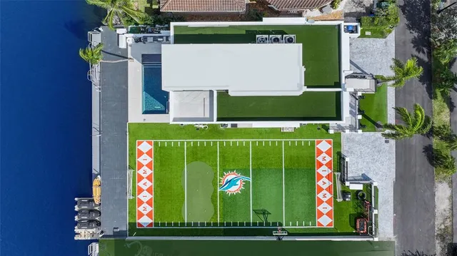 a kitchen with stainless steel appliances a table and chairs in it