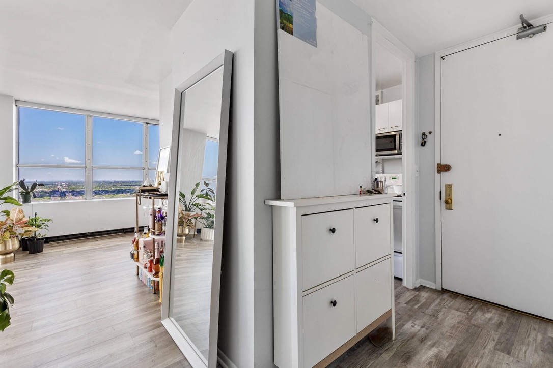 655 West Irving Park Road, Unit 4517 Chicago, IL 60613 - Photo 5 of 27 a view of a kitchen center island cabinets and wooden floor