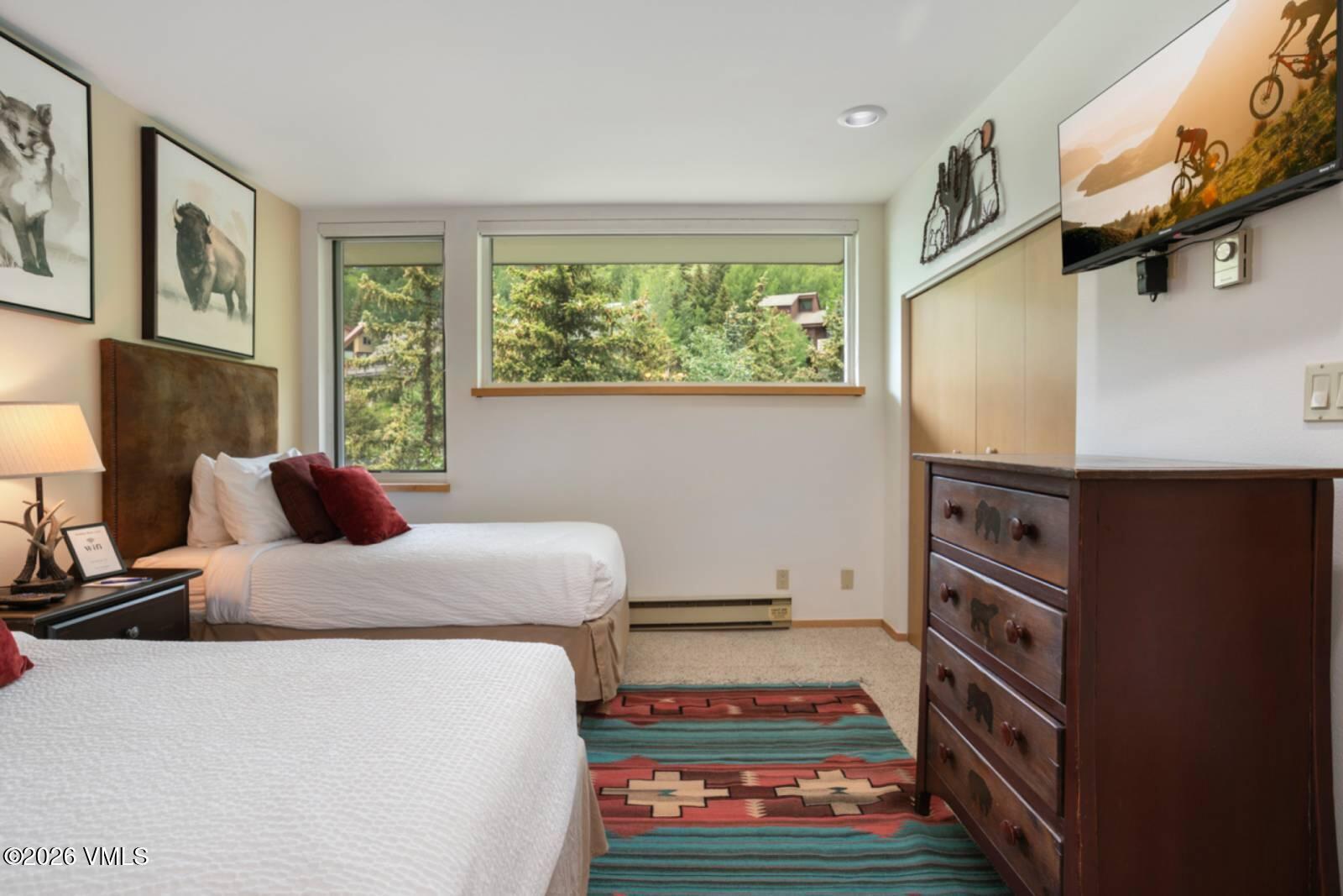 1100 North Frontage Road West, Unit 1519 Vail, CO 81657 - Photo 15 of 38 a bedroom with a bed and a window