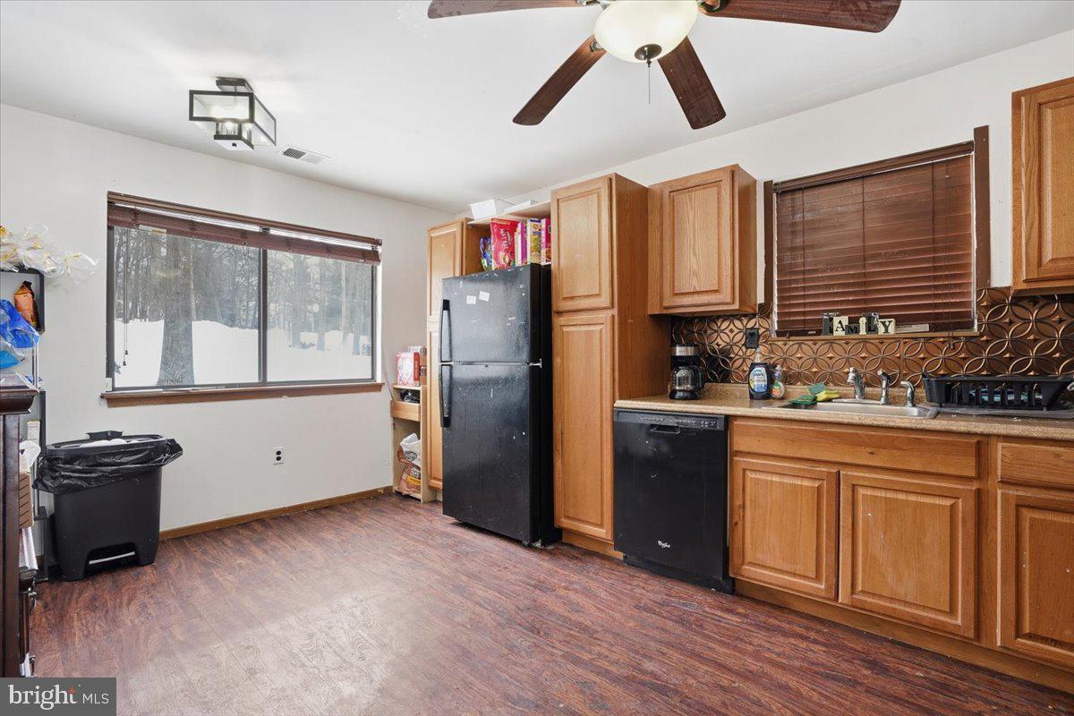 3301 Windemere Drive Bushkill, PA 18324 - Photo 11 of 70 a kitchen with stainless steel appliances granite countertop a refrigerator a stove a sink and dishwasher with wooden floor