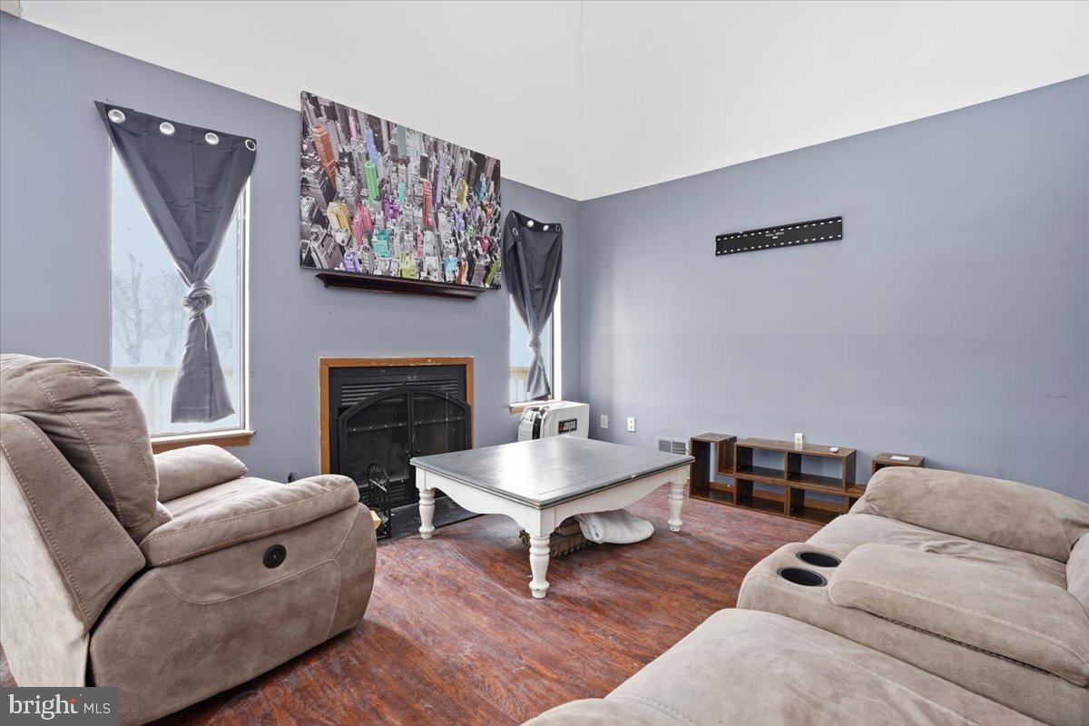3301 Windemere Drive Bushkill, PA 18324 - Photo 5 of 70 a living room with furniture a rug and a fireplace