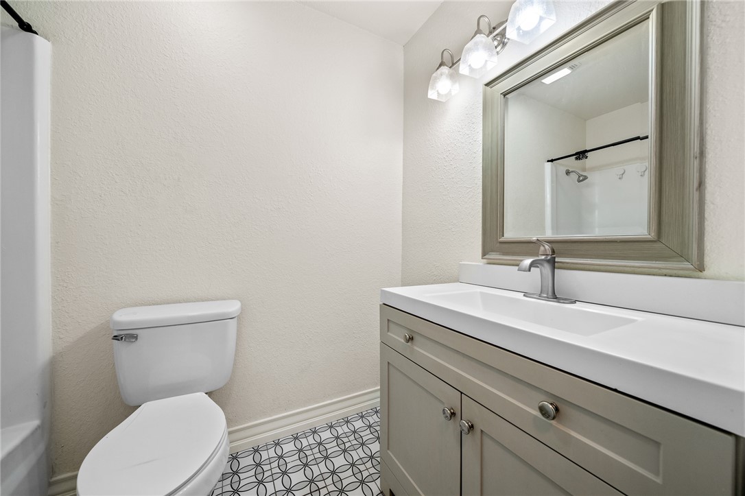 2551 Poinsetta Place Ingleside, TX 78362 - Photo 12 of 21 a bathroom with a toilet a sink and mirror