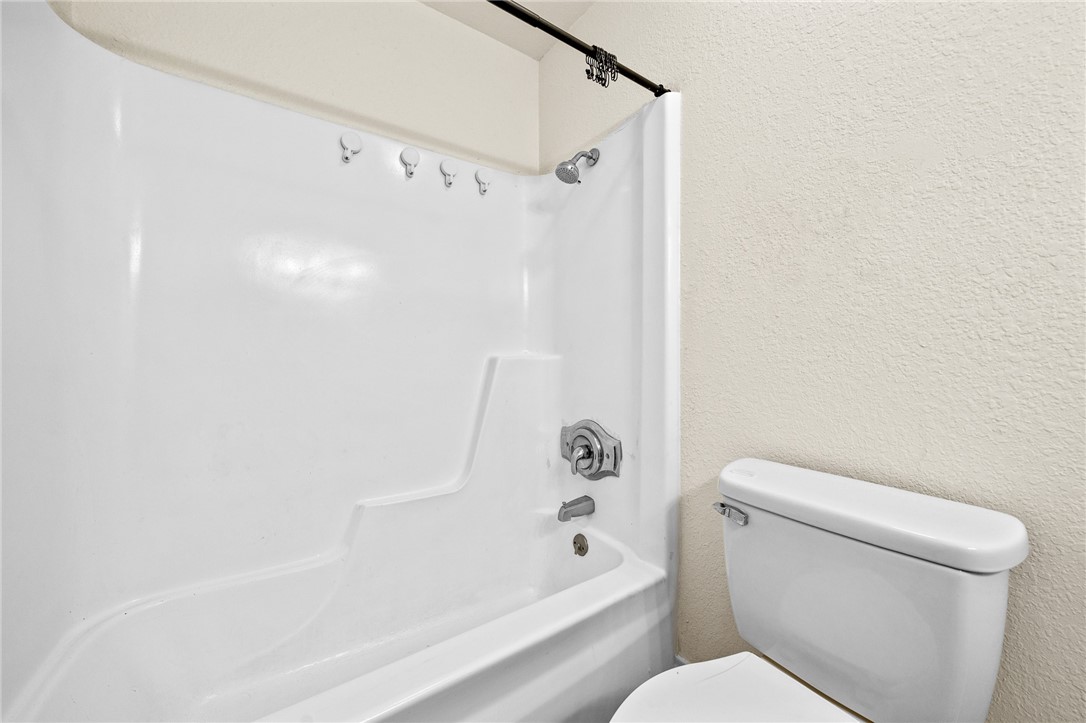 2551 Poinsetta Place Ingleside, TX 78362 - Photo 13 of 21 a bathroom with a toilet and a bathtub