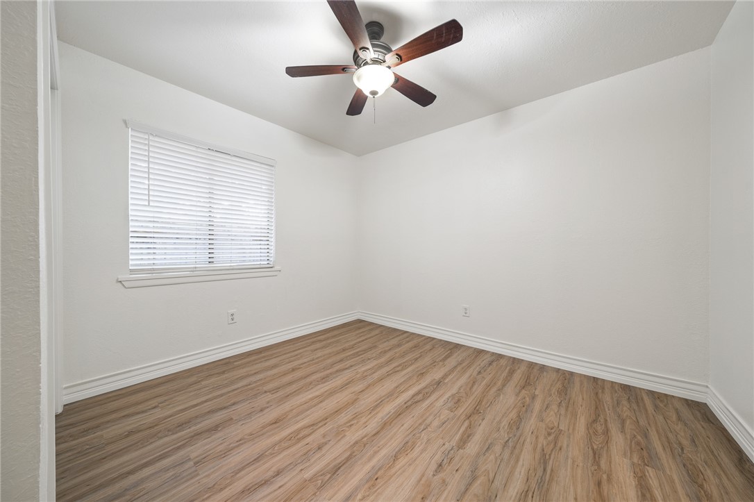 2551 Poinsetta Place Ingleside, TX 78362 - Photo 14 of 21 wooden floor in an empty room with a window