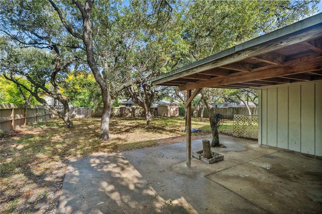 2551 Poinsetta Place Ingleside, TX 78362 - Photo 17 of 21 a view of a backyard with table and chairs under an umbrella