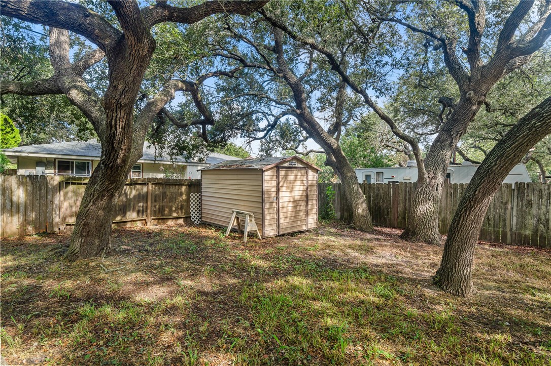 2551 Poinsetta Place Ingleside, TX 78362 - Photo 20 of 21 a view of a house with large tree and wooden fence