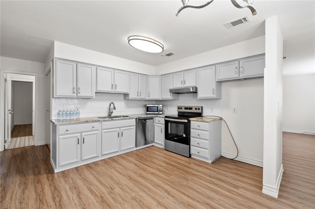 2551 Poinsetta Place Ingleside, TX 78362 - Photo 2 of 21 a kitchen with granite countertop a refrigerator stove top oven and sink
