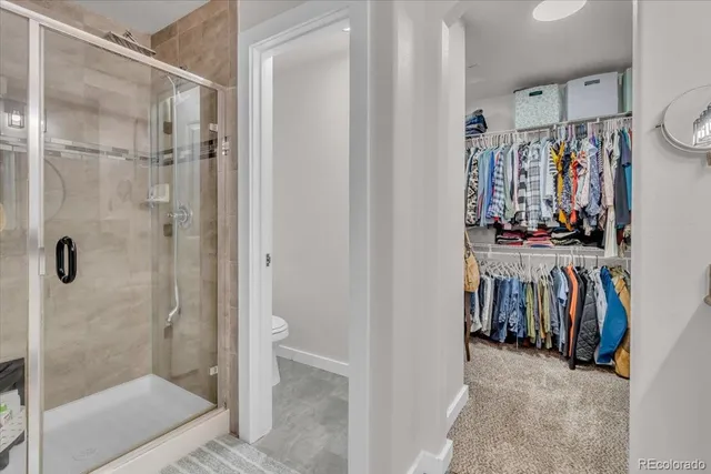 a view of walk in closet with clothes