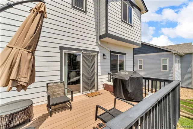 a balcony with furniture and wooden floor