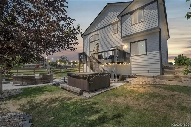 a view of a house with backyard and sitting area
