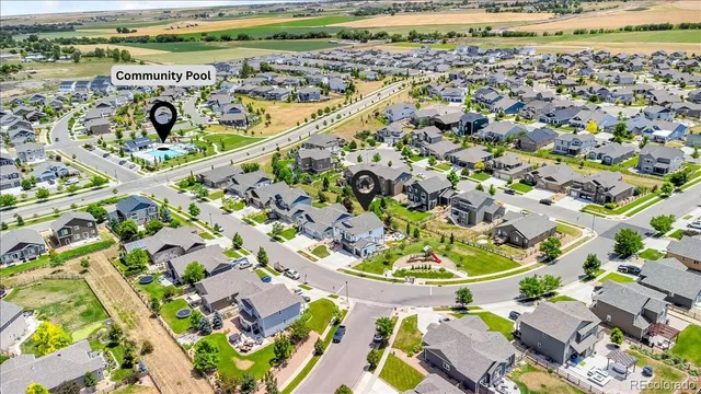 a view of a swimming pool with outdoor seating and wooden floor