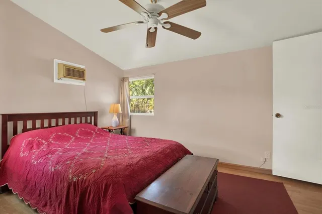 a bed sitting in a bedroom next to a window