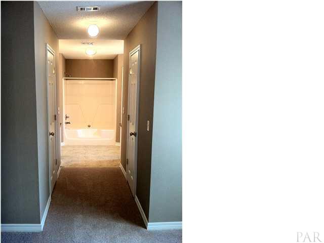 6680 Da Lisa Road Milton, FL 32583 - Photo 15 of 21 Master bath hallway with his & her walk-in closets to the left and right.