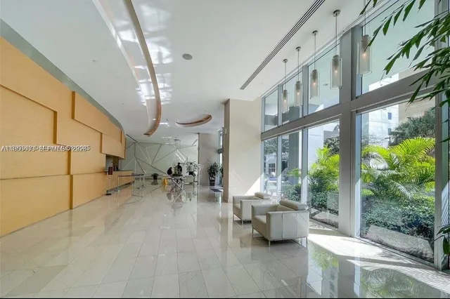 a lobby with furniture and garden view