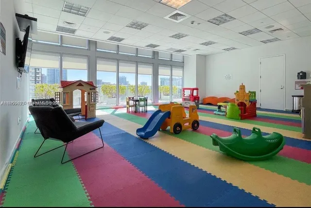 a living room filled with lots of furniture and a table