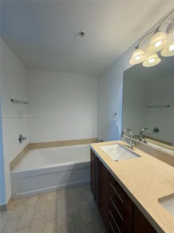 a bathroom with a sink a vanity and bathtub