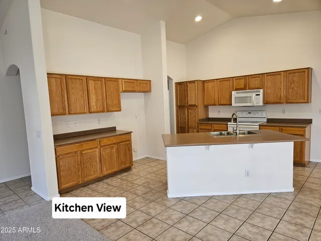 a stove top oven sitting inside of a kitchen