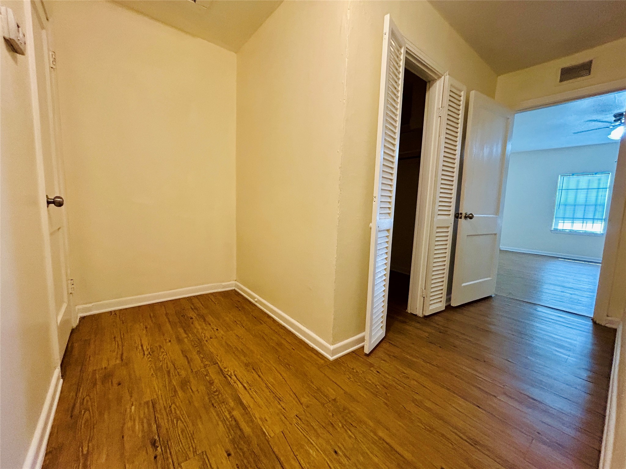 5806 Beldart Street Houston, TX 77033 - Photo 18 of 23 an empty room with wooden floor and entrance