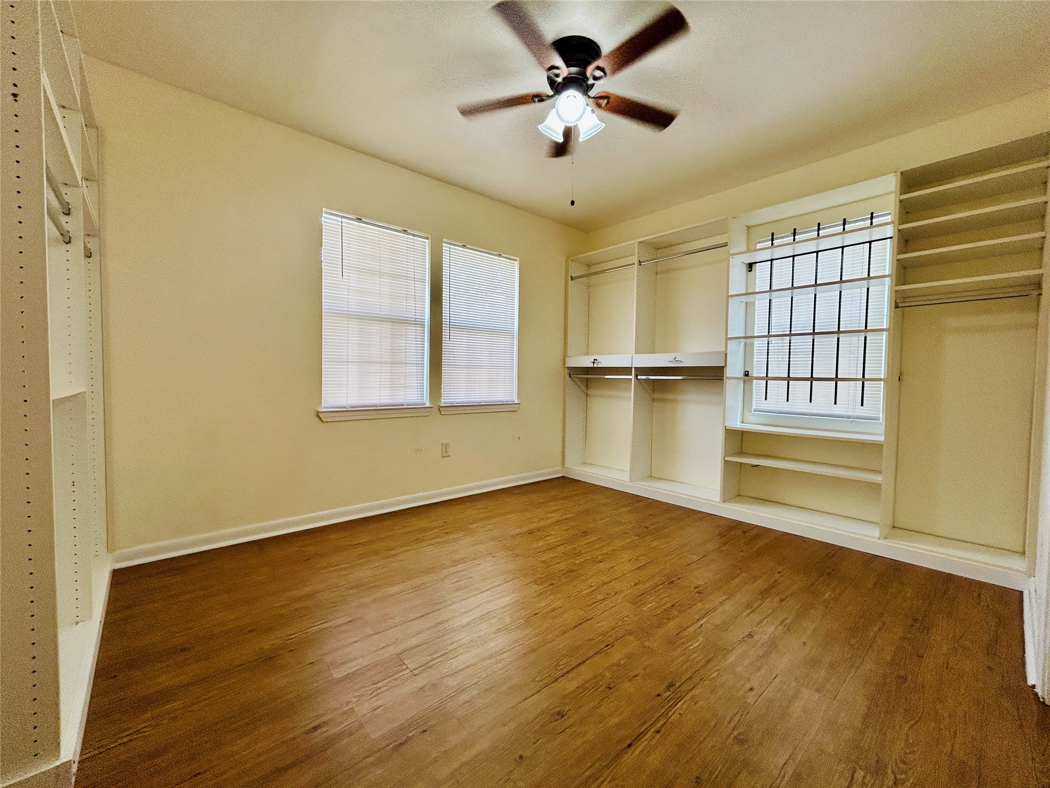 5806 Beldart Street Houston, TX 77033 - Photo 19 of 23 a view of an empty room with a window and wooden floor